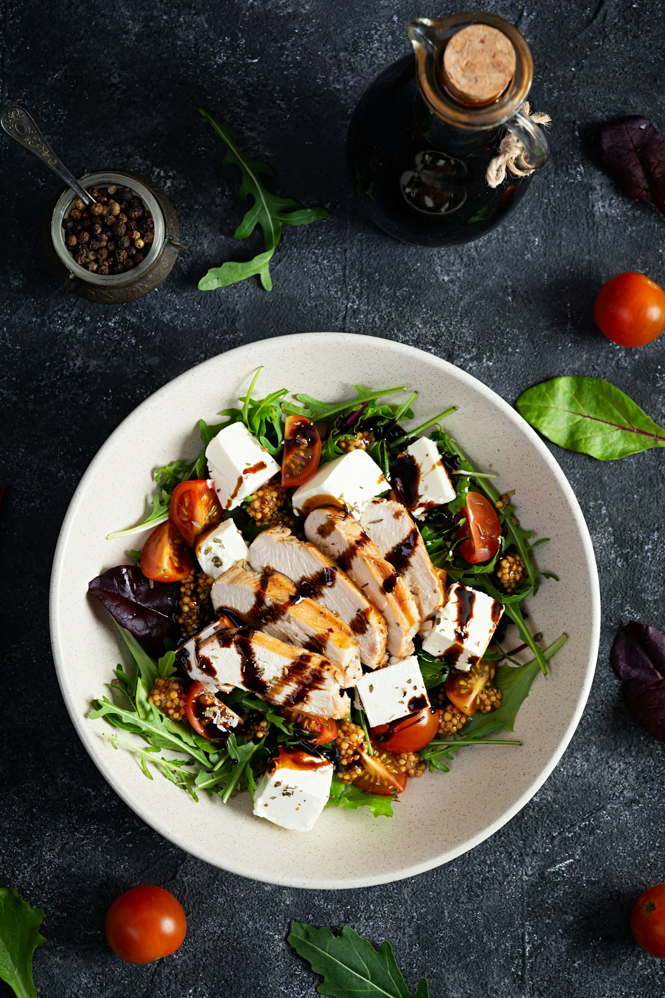 Fresh salad with chicken, tomatoes, herbs and feta cheese. Healthy food. Top view